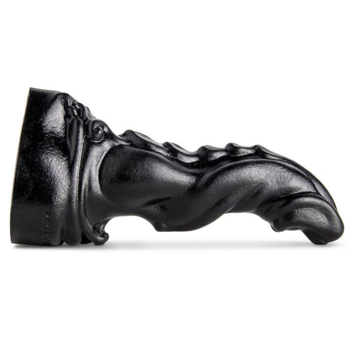 Scimitar Fantasy Dildo by Mr. Hankey’s Toys laying flat, showcasing its scaled back texture and curved design.