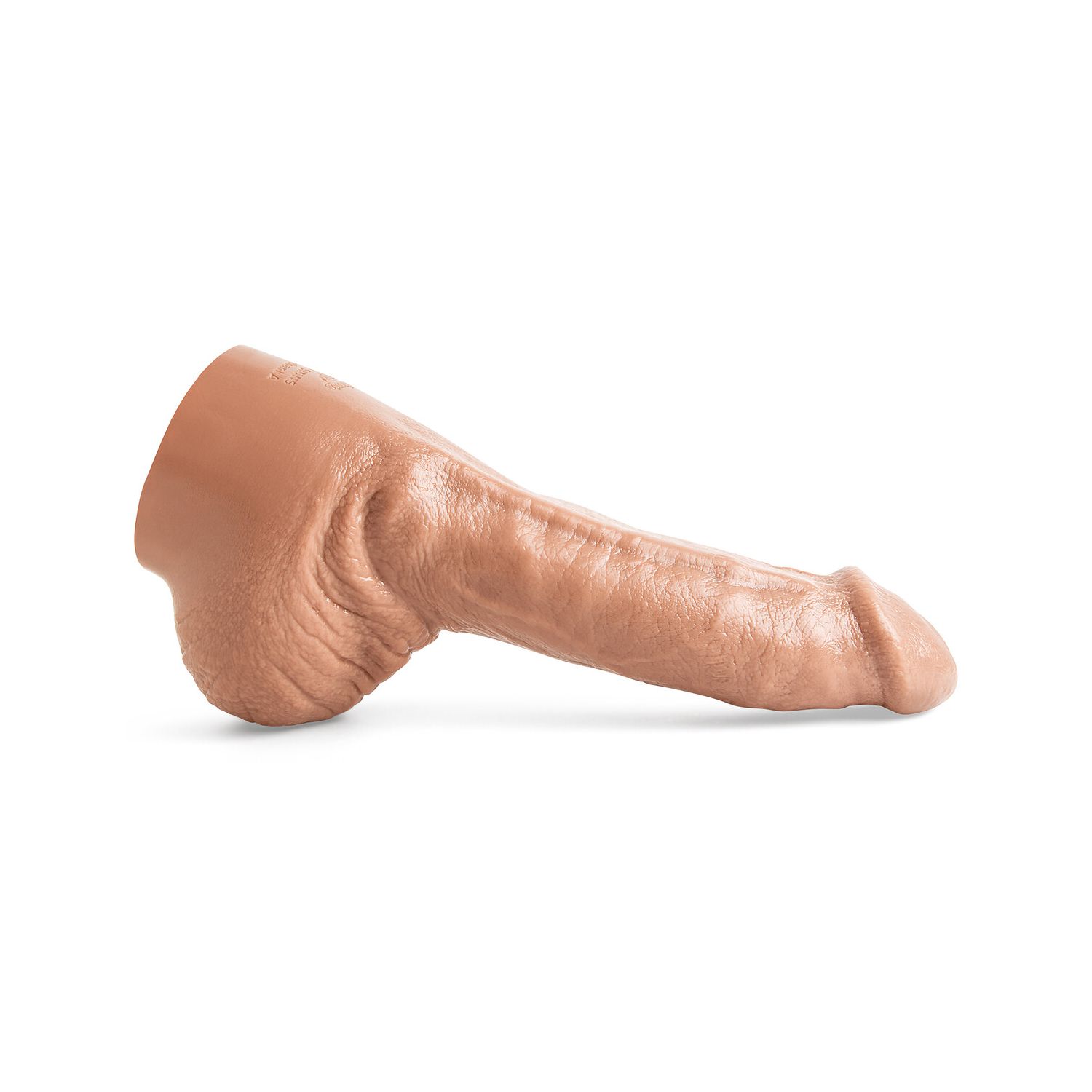 Ethan Sinns realistic dildo in Natural Tan laying flat, showcasing lifecast shaft with pronounced dorsal vein and sculpted anatomical detail.